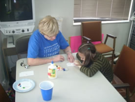 Photo of adult and child doing art work