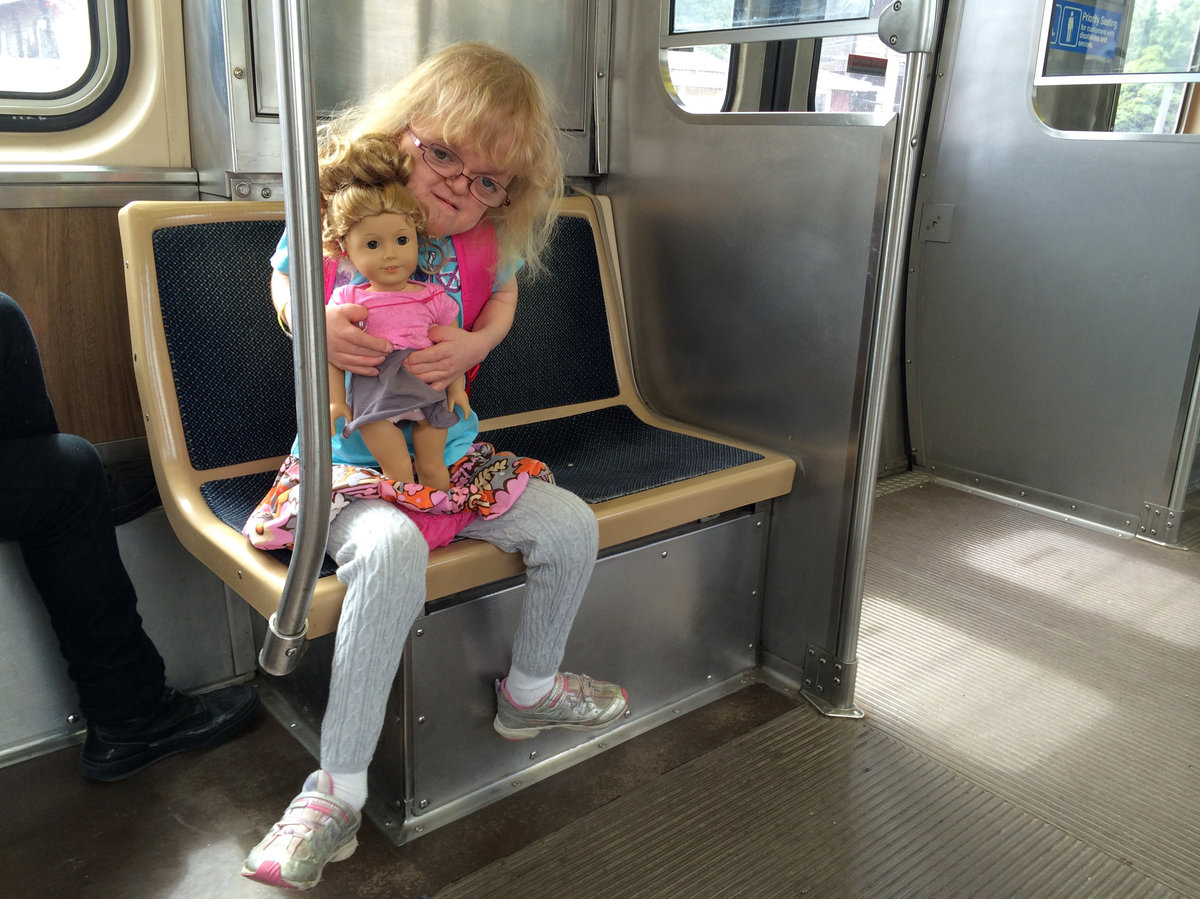 Dominika Tamley and her doll Isebelle ride the train together