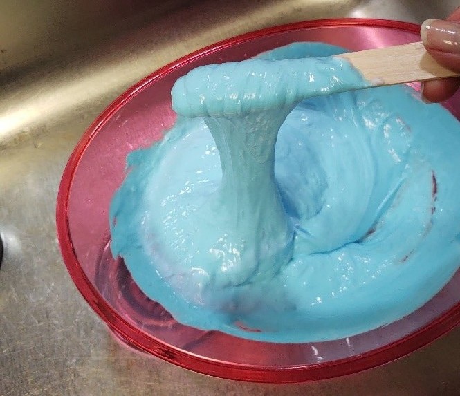 Bowl of slime and slime on a stick.