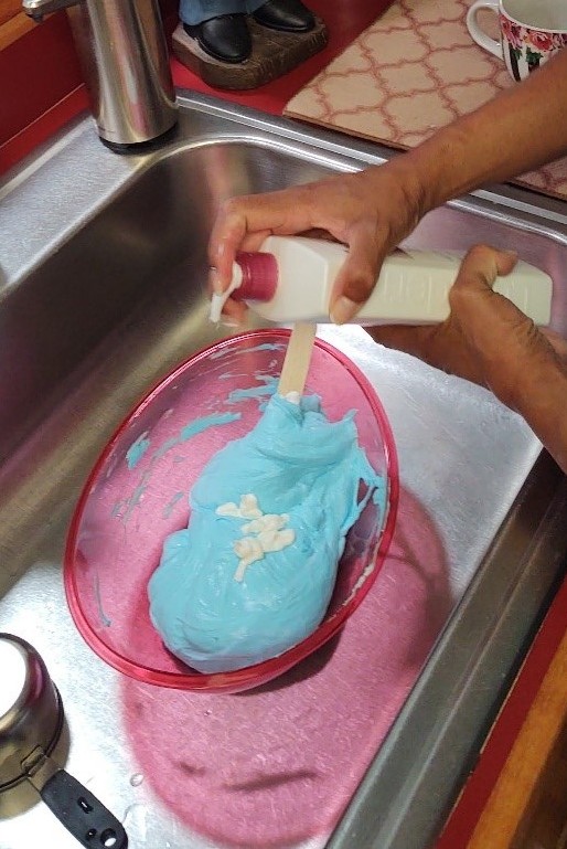 Adding lotion to blue slime.