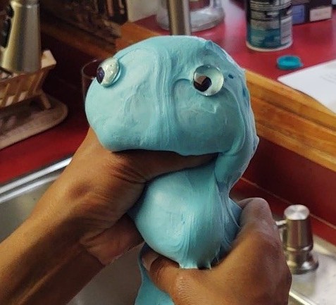 Slime shaped like a worm with googly eyes.